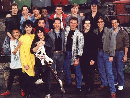 From the "J.A.M. '86" charity record, "We've Got The Love."  E Street Band members Garry Tallent (3rd from right) co-produced, and Max Weinberg (2nd from right) played drums.